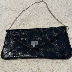 Black faux reptile clutch purse. Chain strap metal closure. Zipper pocket inside